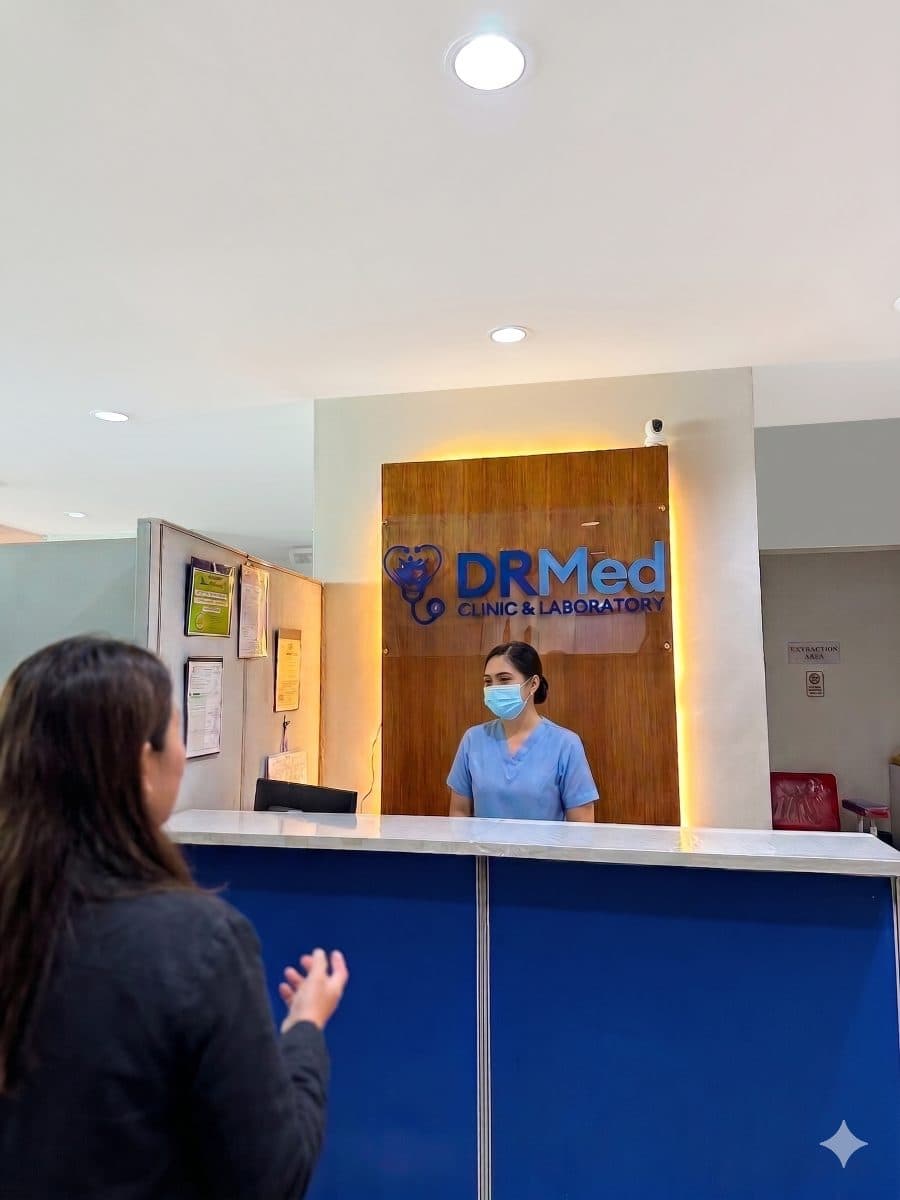 DRMed Clinic and Laboratory reception counter with staff greeting a patient